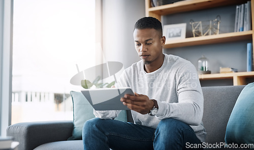 Image of Relax, tablet and man on sofa, internet scroll and reading social media post, email or streaming video on subscription. Mobile app, info and online connection, person surfing movie website on couch.