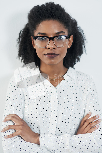 Image of Business portrait, serious and black woman with arms crossed in studio isolated on a white background. Glasses, confidence and face of African female professional, entrepreneur or person from Nigeria