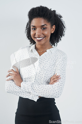 Image of Happy, business and portrait of black woman with arms crossed in studio isolated on a white background. Smile, confidence and face of female professional, entrepreneur or person from South Africa.