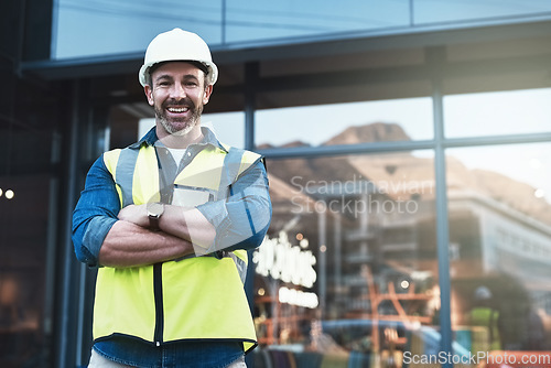 Image of Engineer, portrait of man architect standing in front of construction site and arms crossed. Industrial or architecture, project or management and happy mature male worker with safety helmet