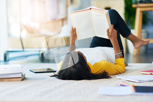 Image of Books, learning student and woman reading literature, research or history book for home school education. College scholarship, university study and person studying knowledge while relax on floor