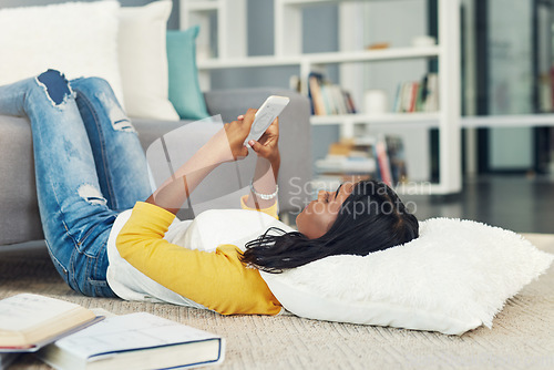 Image of Living room floor, phone and woman typing, texting and search online, internet or app website at home. Scroll, relax and female student on cellphone, mobile research and message social network user