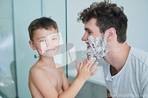 Image of Father, child and portrait while learning to shave in bathroom, having fun or bonding. Smile, kid help and dad with shaving cream on face, playing and cleaning, hygiene and enjoying time together.