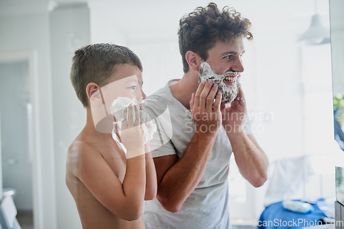 Image of Father, child and teaching how to shave in bathroom, having fun or bonding together. Smile, kid learning and dad shaving cream on face, playing and cleaning, hygiene and enjoying quality time in home