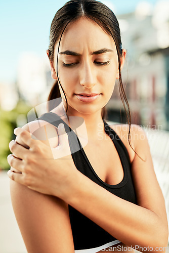 Image of Exercise, fitness and woman with shoulder pain, training and workout with injury, health issue or sports. Female person, girl or athlete with practice, muscle tension and inflammation with broken arm