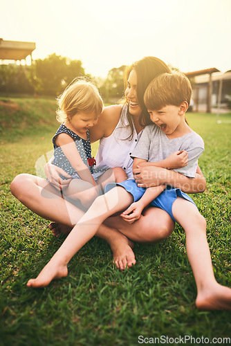 Image of Mother, happy children or hug playing on grass for fun bonding in summer outside a house in nature. Funny mom hugging playful kids siblings on garden playground with happiness of family together