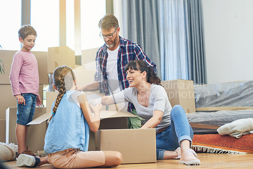 Image of Children, parents and boxes at new home for an investment for a lifestyle with happiness. Family, child and apartment moving box with smile in living room with love and being happy in modern house.