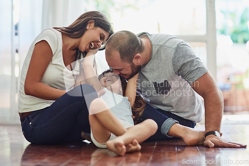 Image of Family, parents with their daughter playing and happy in living room of their home. Love or care, support and cheerful or happy people spend quality or bonding time together on floor at their house.