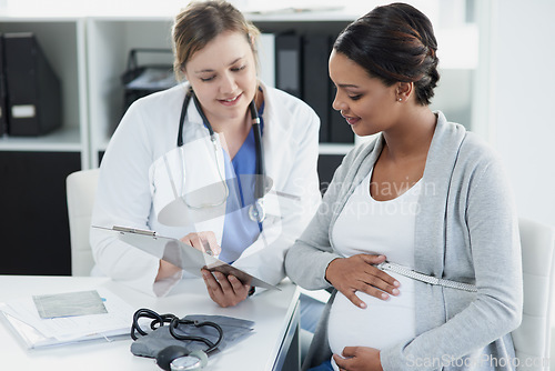 Image of Talking, results and a doctor with a pregnant woman during a consultation for progress on a baby. Communication, smile and a hospital worker speaking to a patient about healthcare during a pregnancy