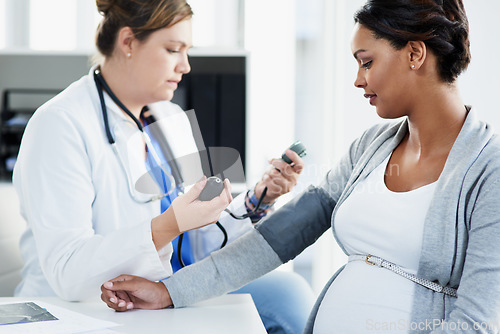 Image of Blood pressure, healthcare and doctor with a pregnant woman for a consultation of health. Hospital, wellness check and a medical worker with a patient consulting about hypertension during pregnancy