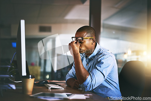 Image of Black business man, stress and fatigue in night, office and headache by computer for project deadline. African businessman, burnout or anxiety in workplace by pc, web design startup and mental health