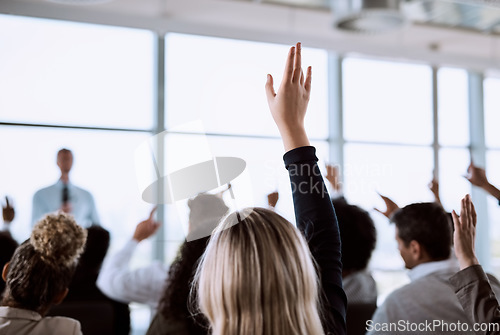 Image of Conference, crowd and business people with hands for a question, vote or volunteering. Corporate event, meeting and hand raised in a training seminar for questions, voting or audience opinion