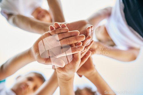 Image of Low angle, partnership and close up of hands or group of siblings in solidarity or team together and on bokeh outdoors. Trust, stacked palms and brothers or sisters or children playing outside focus