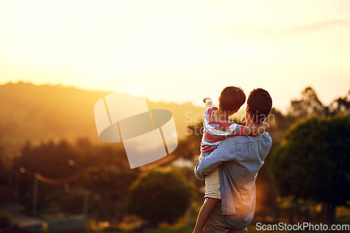 Image of Father, child and pointing to sunset in nature for travel, holiday or weekend getaway outdoors. Back of dad holding kid enjoying the future, sunrise or horizon for family bonding on mockup space