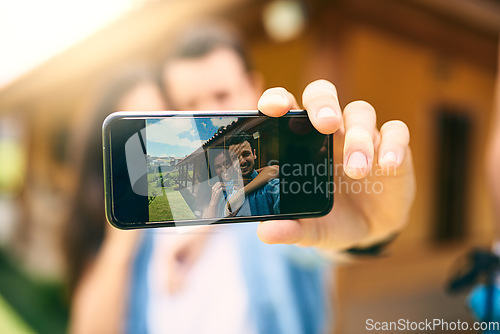 Image of Happy couple, hug and phone screen for selfie, photo or profile picture together in relationship outdoors. Hand of man holding smartphone with woman hugging for love, memory or capture outside home