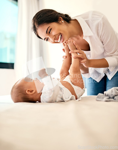 Image of Happy, love and a mama with her baby in the bedroom of their home together for playful bonding. Family, children and a young mother spending time with her newborn infant on the bed for fun or joy