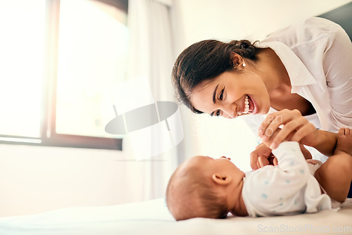 Image of Happy, love and a mother with her baby in the bedroom of their home together for playful bonding. Family, children and a young mama spending time with her newborn infant on the bed for fun or joy