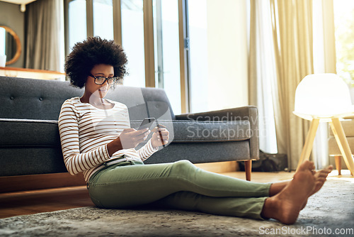 Image of Black woman, phone and credit card in living room for ecommerce, payment or purchase at home. African female person or shopper sitting on floor with smartphone or debit for online shopping or banking