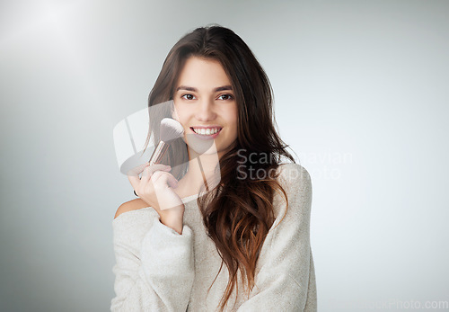 Image of Face, beauty and makeup brush of a happy woman in studio with a natural glow and smile. Portrait of a female person on a grey background with mockup for cosmetology, powder cosmetics and skin care