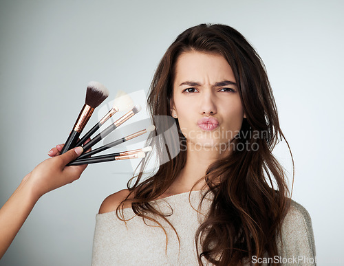 Image of Beauty, face and makeup brush for a woman in studio with a natural glow and lips. Portrait of a female person on a grey background for cosmetology transformation, cosmetic tools and facial skin care