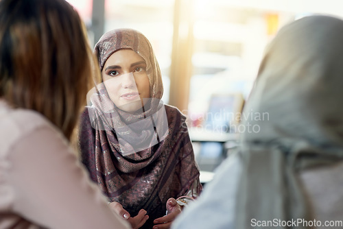 Image of Conversation, friends and Muslim women in cafe, bonding and speaking together. Coffee shop, relax and Islamic girls, group or people talking, chat and discussion for social gathering in restaurant