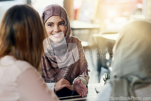 Image of Friends, happy and Muslim women in cafe, bonding and talking together. Coffee shop, smile and Islamic girls, group or people chat, conversation and discussion for social gathering in restaurant.