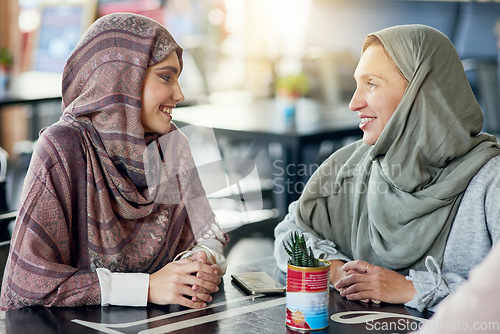 Image of Friends, happy and Muslim women in cafe, bonding and talking together. Coffee shop, relax and Islamic girls, group or people chat, conversation and discussion for social gathering in restaurant.