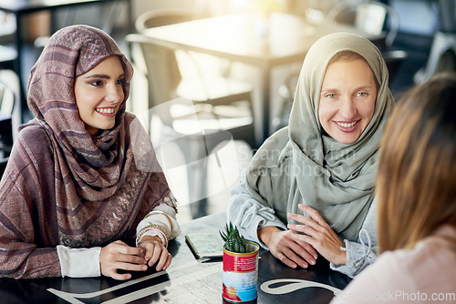 Image of Happy, friends and Muslim women in coffee shop, bonding and talking together. Cafe, relax and Islamic girls, group or people chatting, conversation and discussion for social meeting in restaurant.