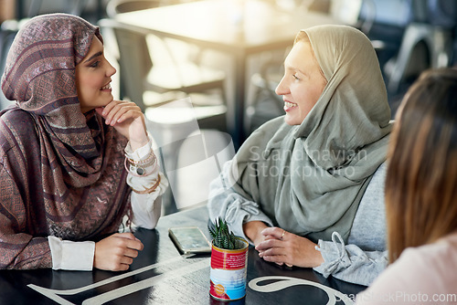 Image of Smile, friends and Muslim women in coffee shop, bonding and talking together. Cafe, relax and Islamic girls, group or people chat, conversation and discussion for social gathering in restaurant.