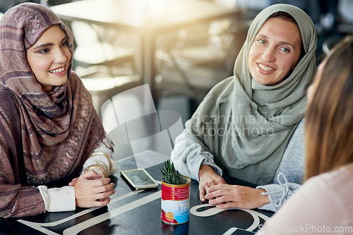 Image of Friends, relax and Muslim women in coffee shop, bonding and talking together. Cafe, happy and Islamic girls, group or people chatting, conversation and discussion for social meeting in restaurant.