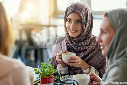 Image of Friends, smile and Muslim women in coffee shop, bonding and talking together. Cafe, happy and Islamic girls, group or people chatting, conversation and discussion for social meeting in restaurant.