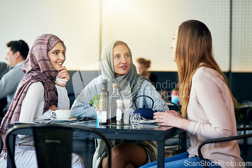 Image of Friends, smile and Muslim women in cafe, bonding and talking together. Coffee shop, happy and Islamic girls, group or people chat, conversation and discussion for social gathering in restaurant.