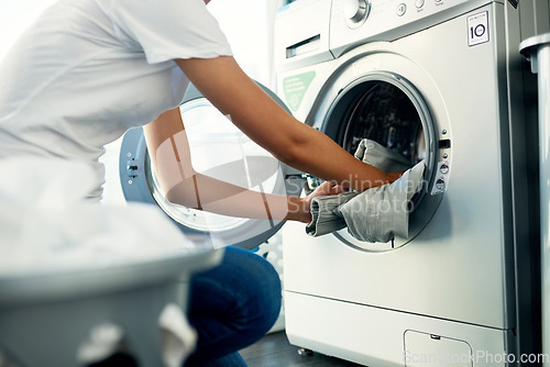 Image of Closeup, cleaning and woman with laundry, machine and home with clothes, fabric and housekeeping. Zoom, female person and cleaner washing items, housework and laundromat with routine and service