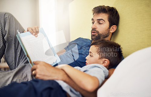 Image of Family, father and son with a book, home or reading with bonding, development and relax in a bedroom. Happy parent, male child or kid with dad, literature and learning on a bed, love and storytelling