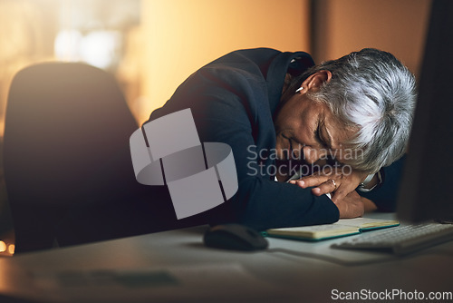 Image of Burnout, night and businesswoman sleeping in the office to complete a deadline project. Exhausted, tired and mature professional female employee taking a nap while working overtime in the workplace.