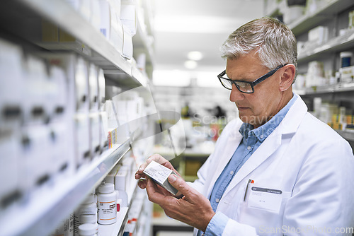 Image of Pharmacy, medicine and check with man at shelf in drug store for label, inspection and inventory. Medical, healthcare and pills with male pharmacist in clinic for expert, wellness and product check