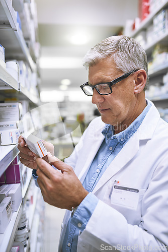 Image of Pharmacy, medicine and reading with man at shelf in store for inspection, search and inventory. Medical, healthcare and pills with senior male pharmacist in clinic for expert, wellness and product