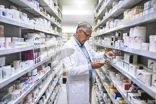 Image of Pharmacy, medicine and search with man at shelf in drug store for thinking, inspection and inventory. Medical, healthcare and pills with senior male pharmacist for expert, wellness and product