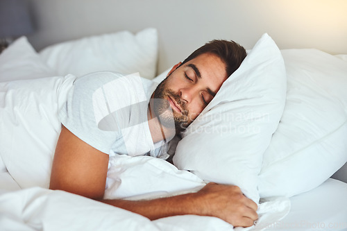 Image of Man, sleeping and bed in morning rest for healthy wellness, peace and quiet on comfort pillow at home. Tired or exhausted male person asleep or dreaming on peaceful holiday or weekend in the bedroom