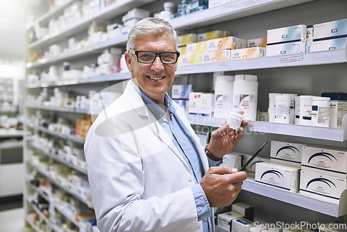 Image of Pharmacy, medicine and tablet with portrait of man at shelf in store for stock, inspection and inventory. Medical, healthcare and pills with senior pharmacist for technology, wellness and product