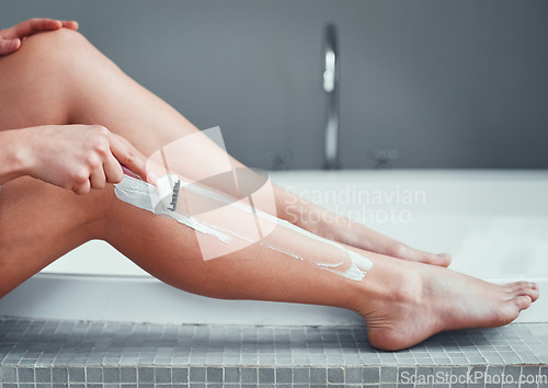 Image of Legs, shaving razor and woman in home bathroom for hair removal, epilation and self care. Female person with hand for skincare, cleaning body and grooming with foam or soap for health and wellness