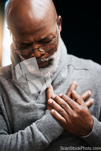 Image of Hands on chest, heart attack and elderly black man with medical emergency in home. Pain, cardiology and African male person with cardiac arrest, heartburn or stroke, problem or retirement health risk