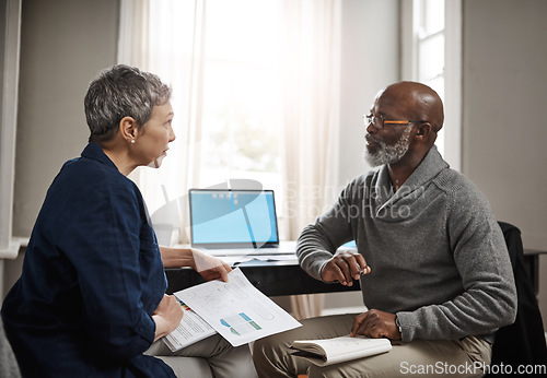 Image of Laptop, documents and accounting with a senior couple busy on a budget review in the home together. Finance, taxes or investment planning with a mature man and woman looking at insurance or savings