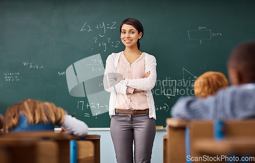 Image of Portrait, woman and teacher in a classroom, arms crossed and education with happiness, employment and career. Face, female person and employee with skills, maths and smile with educator and knowledge