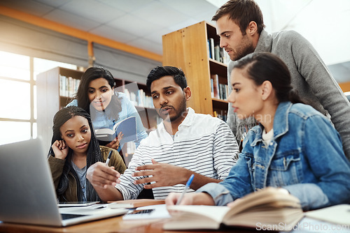 Image of Computer, talking and students studying in a library for a group project, teamwork and education. Learning, laptop and friends speaking about university notes, knowledge and planning research