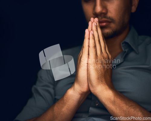 Image of Praying, worship and hope with hands of man for religion, spirituality and faith. Focus, thinking and peace with closeup of person and mockup space on dark background for belief, prayer and gratitude