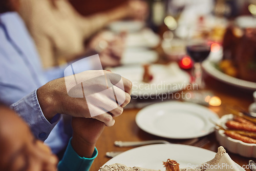 Image of Prayer, Christmas and hand holding with family at table in dining room for holiday, food or worship. Celebration, support and gratitude with closeup of people at home for kindness, dinner and love