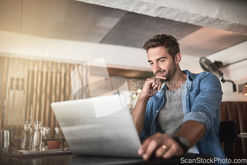 Image of Thinking, laptop and man doing research in a coffee shop and reading for a freelance assignment. Pensive, technology and male freelancer working on a project with a computer at a cafe or restaurant.