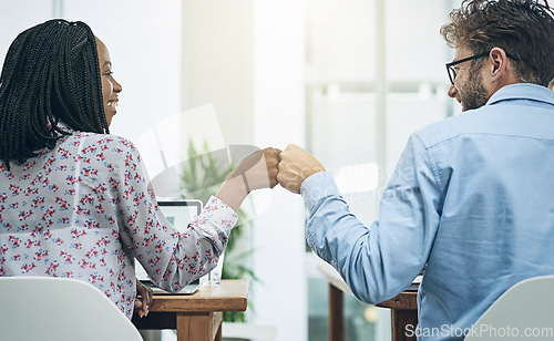 Image of Back, teamwork and fist bump with business people in their office, working together on a company project. Motivation, collaboration and hand gesture with colleagues celebrating success at work