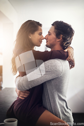 Image of Intimate, passion and a couple kissing in the kitchen of their home together in the morning for romance. Kiss, love or sexy with a man and woman in their house for romantic intimacy or bonding